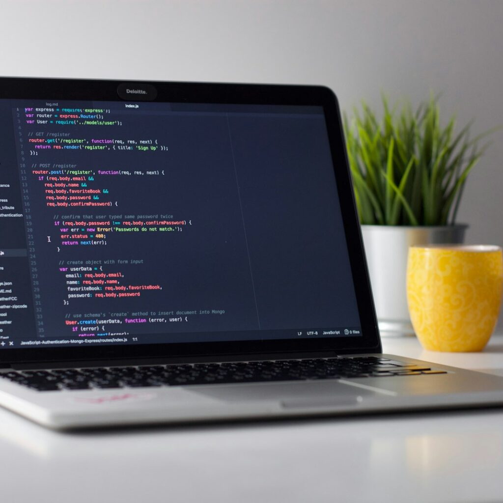 Developer writing mobile app code on a laptop