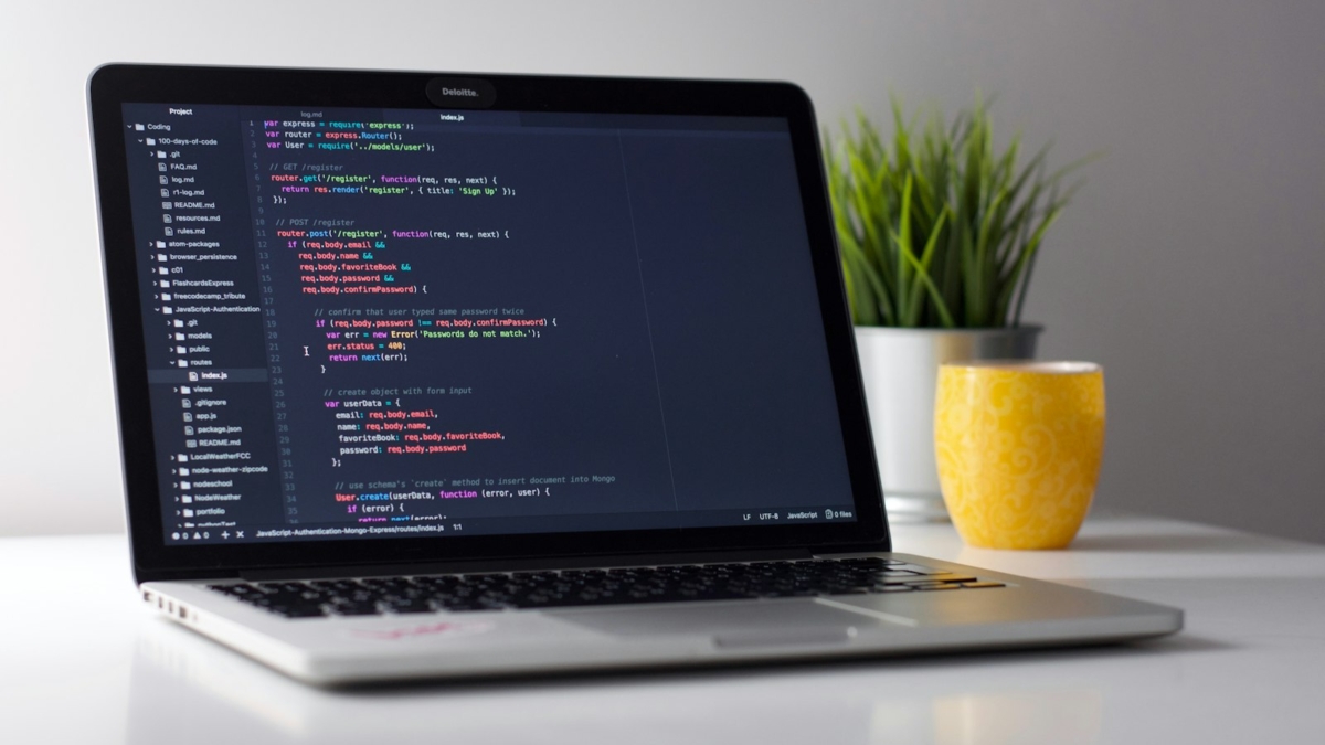 Developer writing mobile app code on a laptop