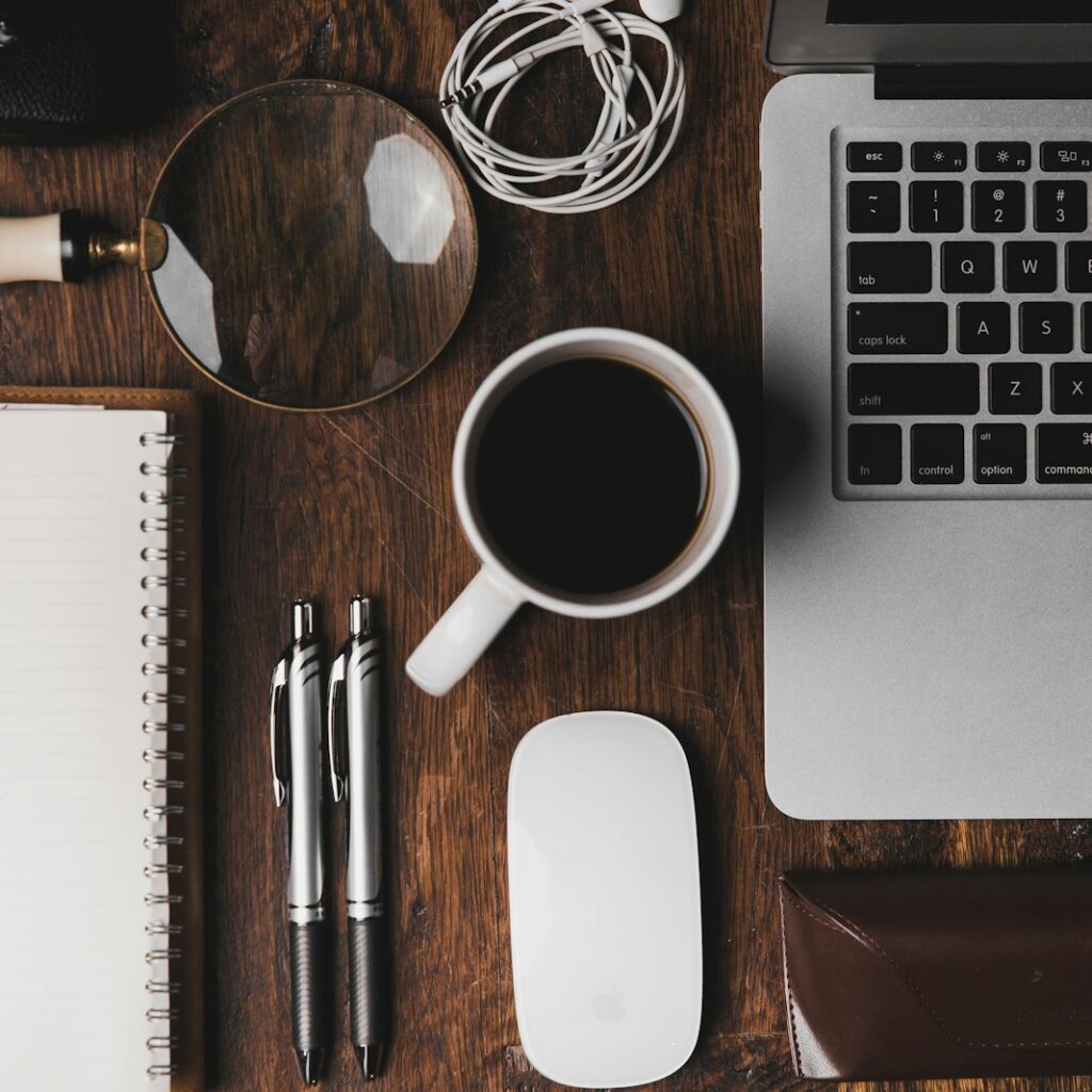Office desk with laptop and notebook