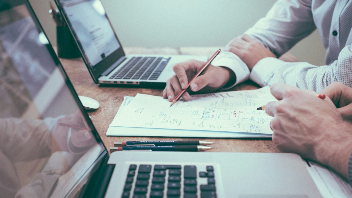 Planning a website budget with charts and a laptop