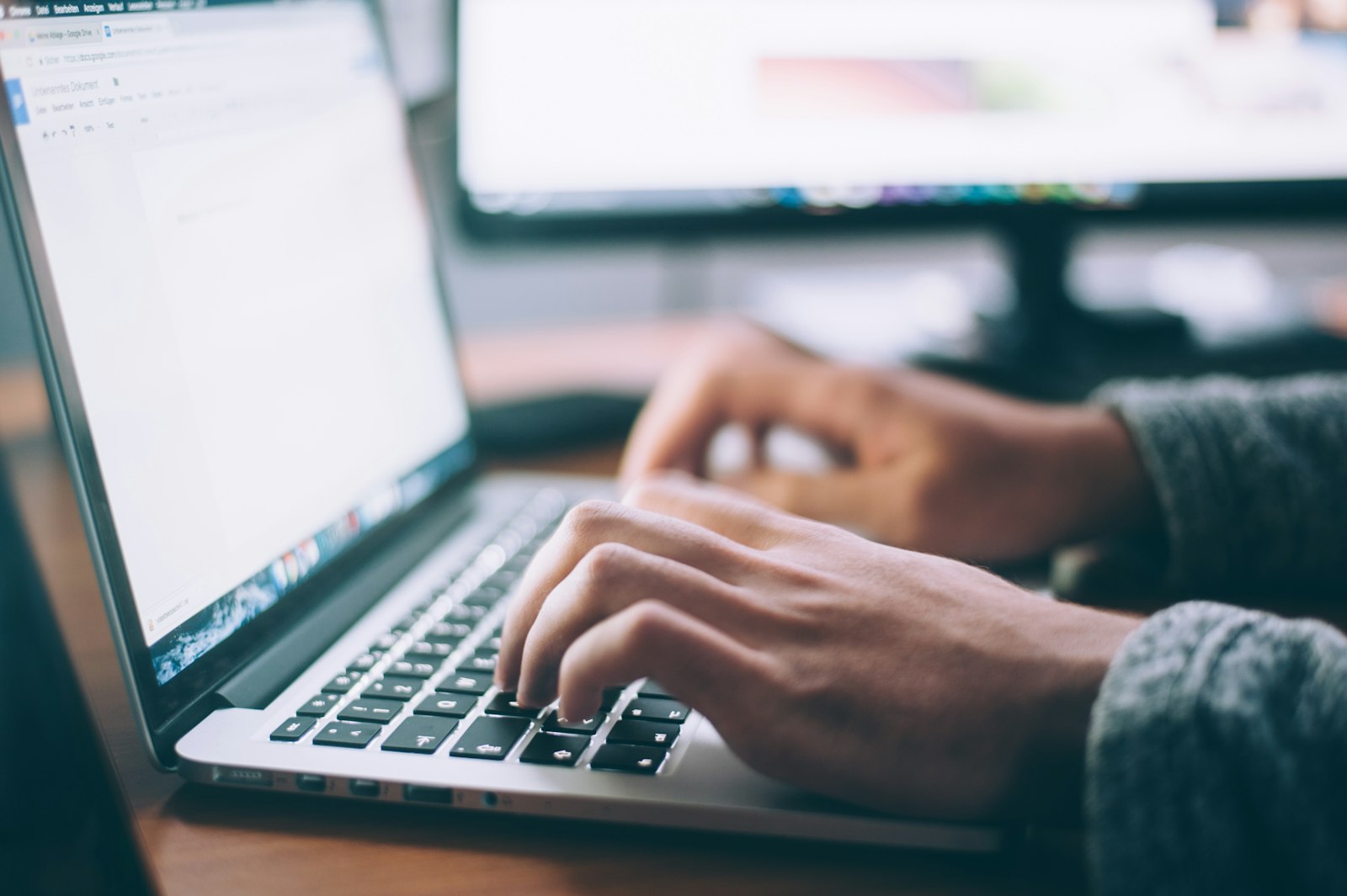 Typing a professional email on a laptop
